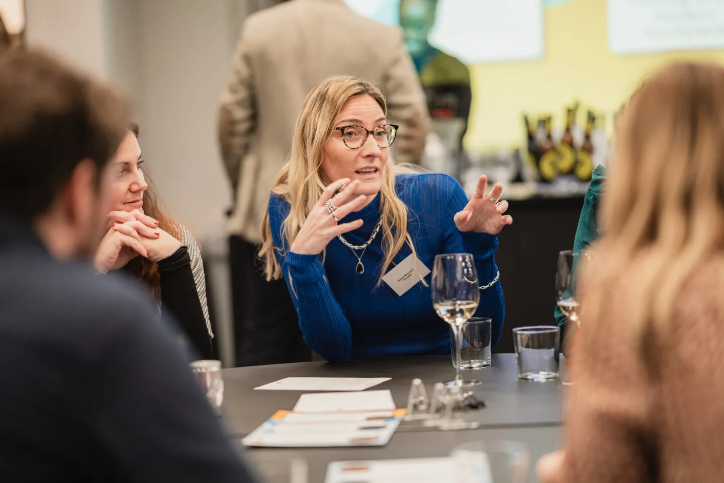 A delegate addressing a table of people.