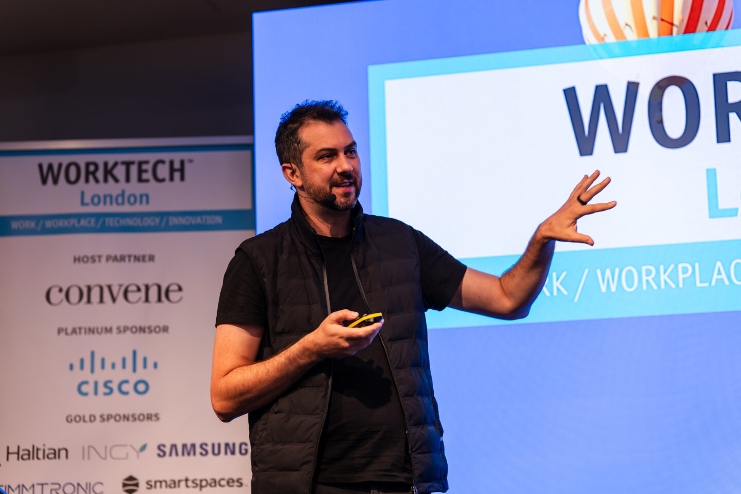 Daniel Hulme speaking on stage at a WORKTECH conference