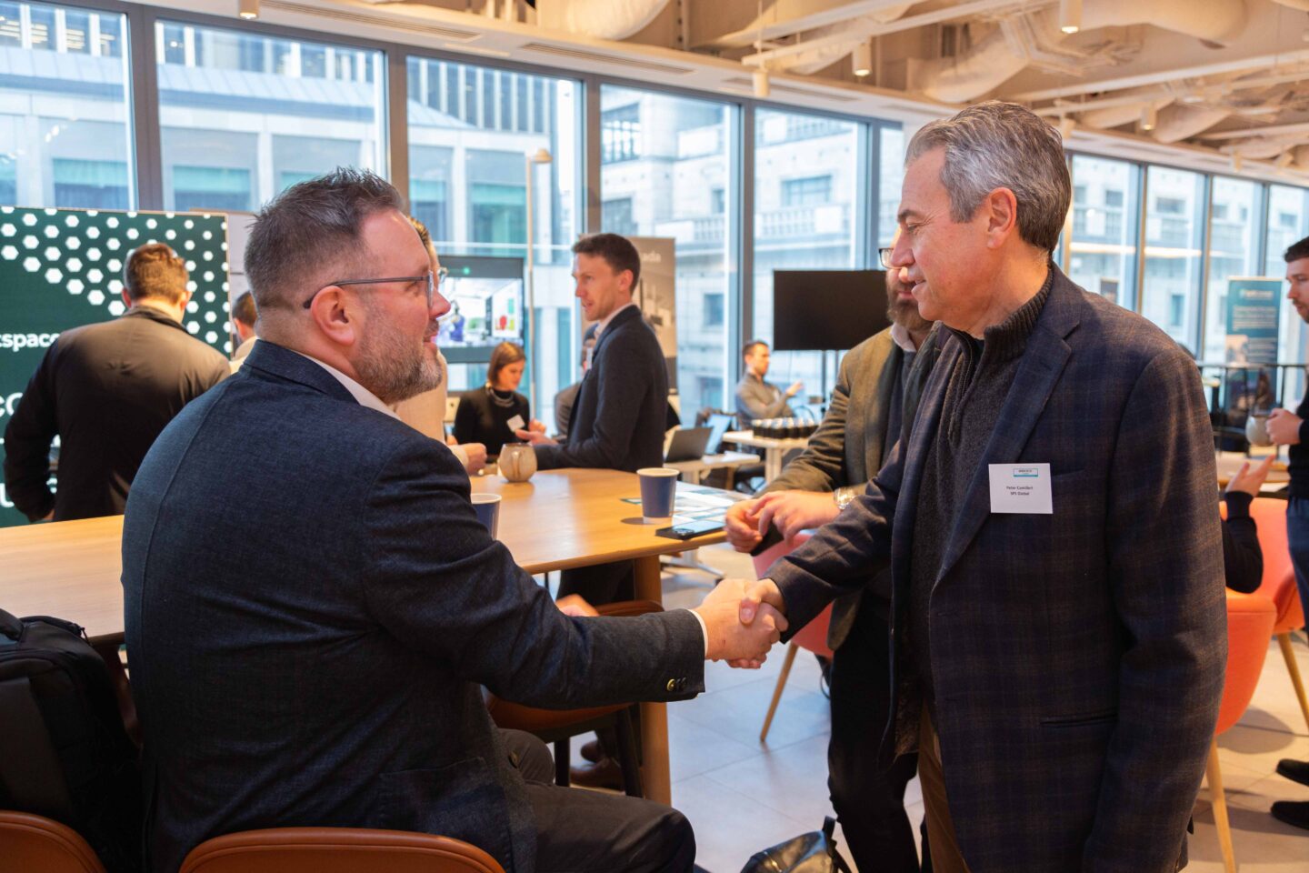 Sponsors shaking hands at a future of work conference