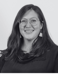 A woman with dark, shoulder length hair and glasses.