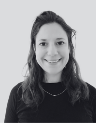 A woman with shoulder length dark hair wearing a dark crew neck top
