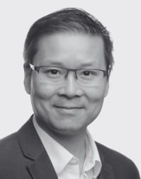 A short haired businessman wearing glasses