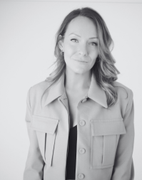 A headshot of a woman with shoulder length blonde hair wearing a smart jacket