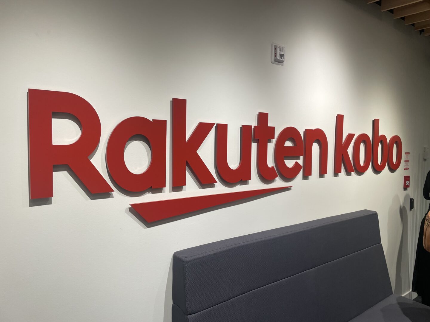 An image of the Rakuten kobo lobby featuring their logo on a wall