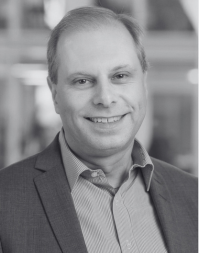 A male business professional wearing a shirt and suit jacket