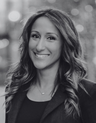 A business woman with shoulder length wavy hair.