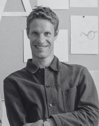 A short haired man wearing a casual shirt