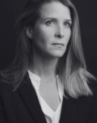 A business woman wearing a white shirt and dark jacket