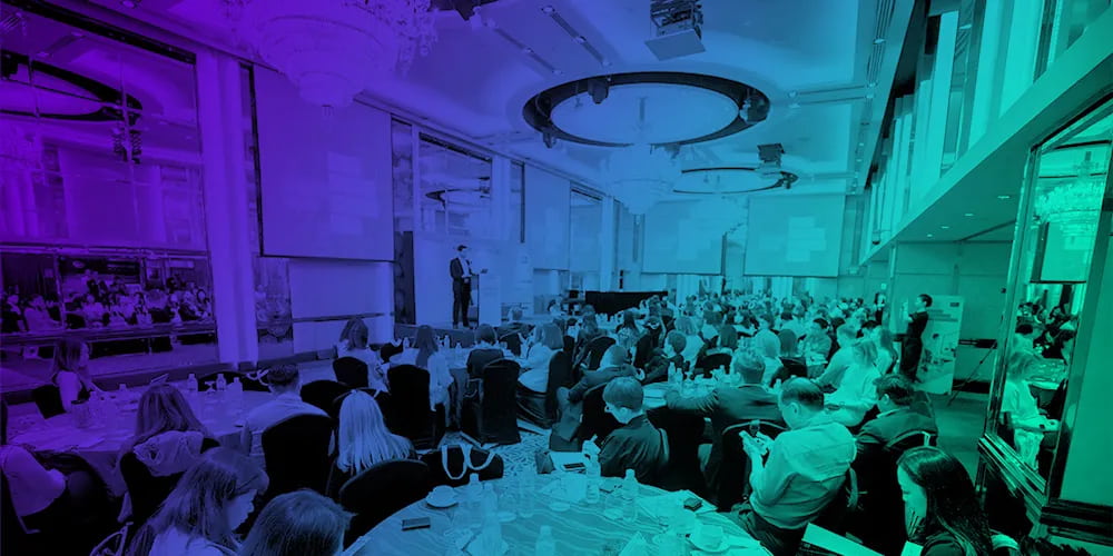 Conference event room with audience in blue and green colour tone